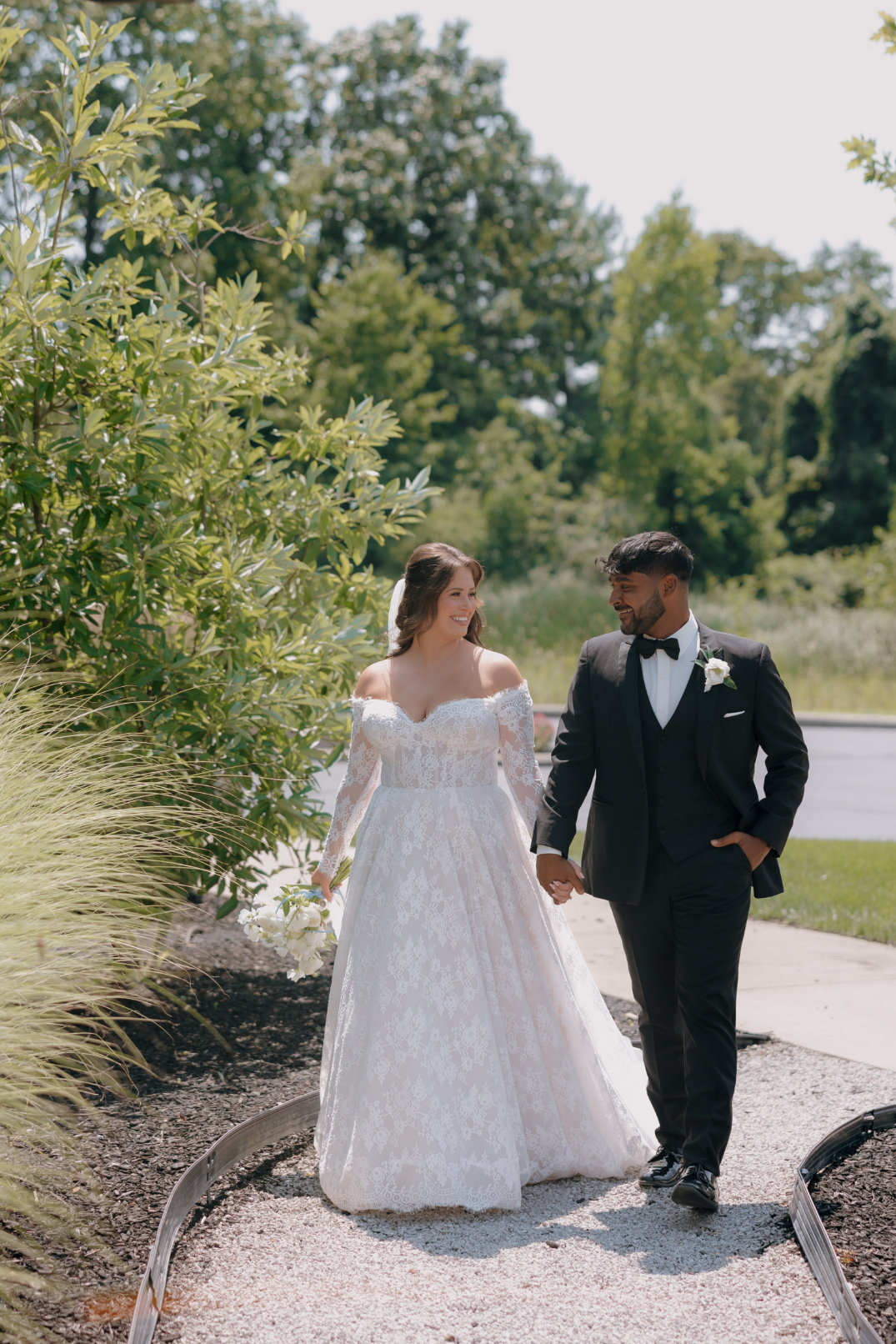 Bride and groom walking together outdoors after the ceremony.