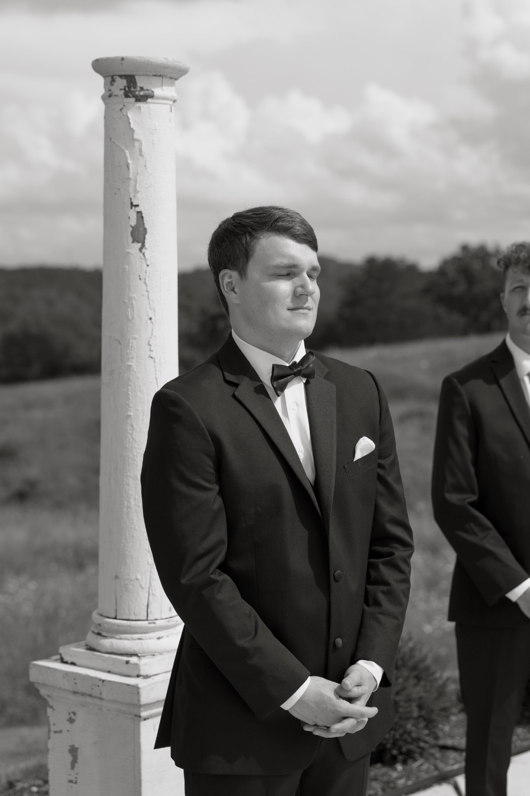 Black and white film portrait of the groom standing at the altar at The Seventy Five Venue in Hocking Hills, Ohio, captured by Chloe Elizabeth Photography.