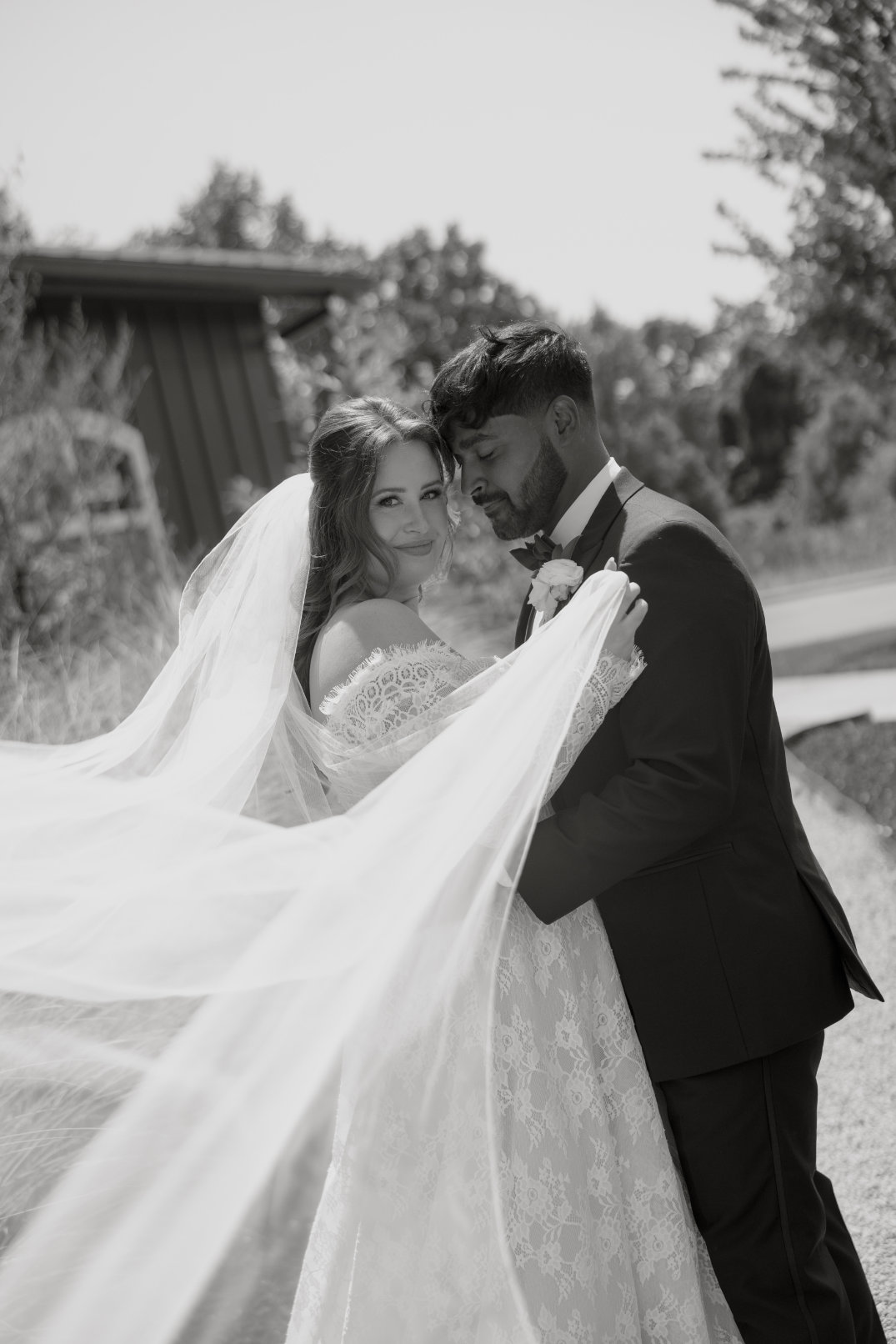 Black and white portrait of the couple sharing a moment outdoors.