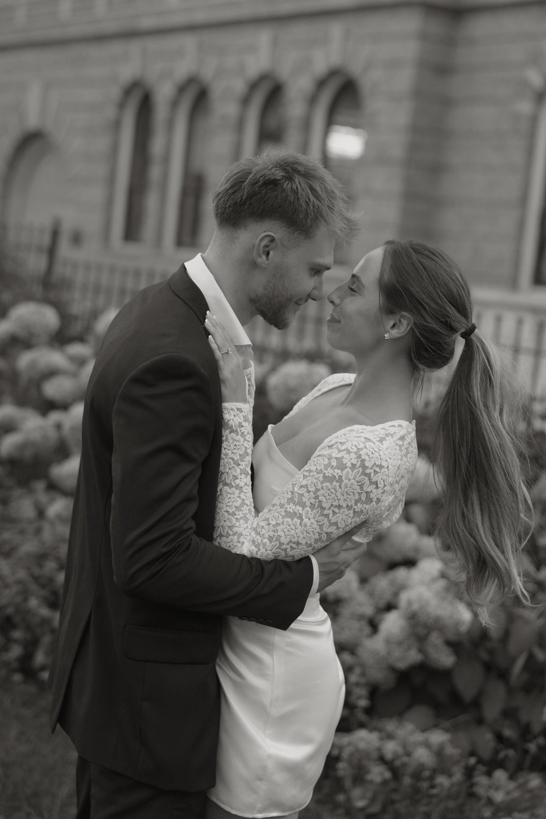 Black and white image of the couple about to kiss in an intimate moment, captured by Ohio film photographer.