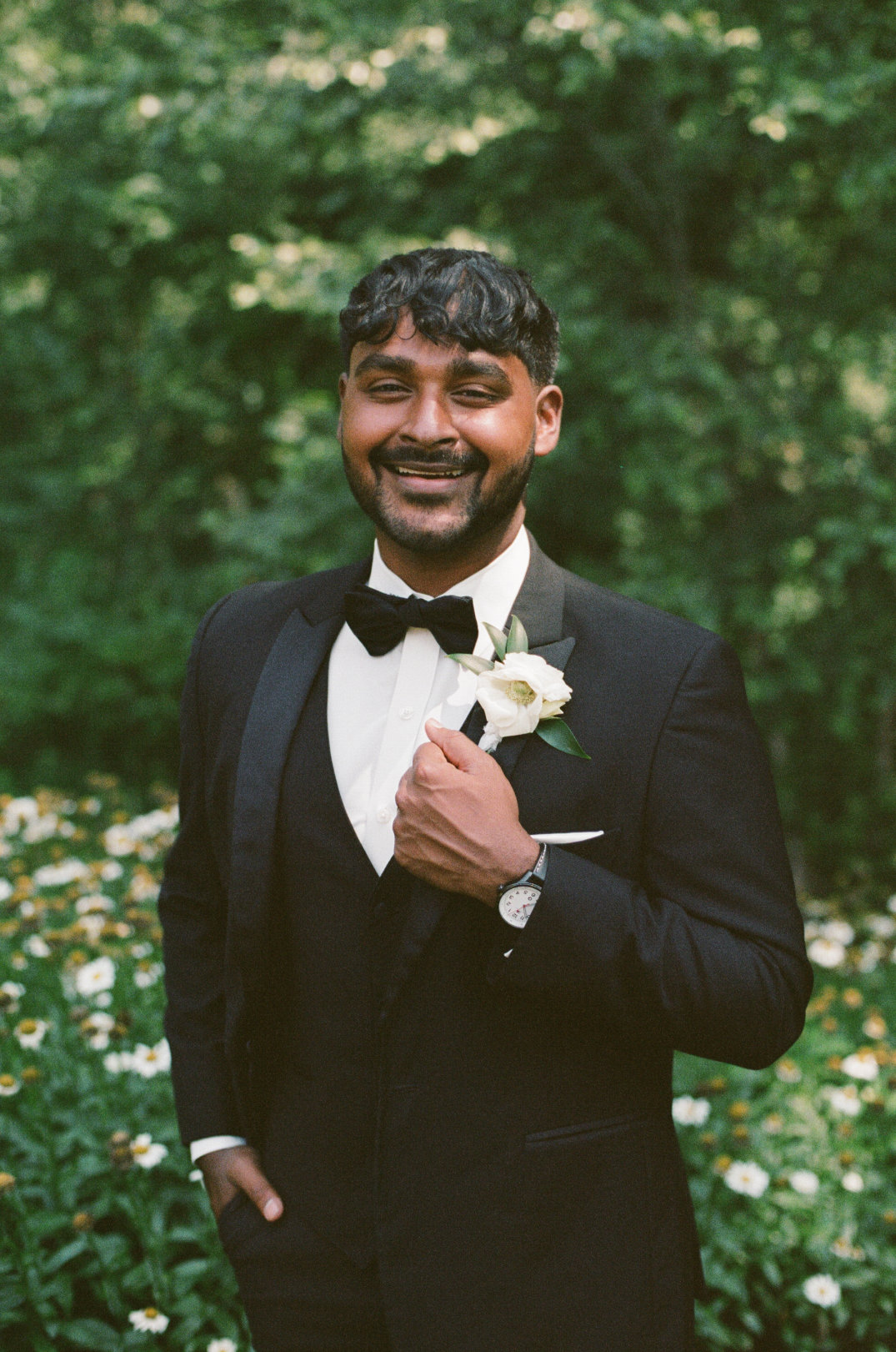 Groom smiling directly at the camera in his tuxedo, standing in natural light in Columbus, Ohio.