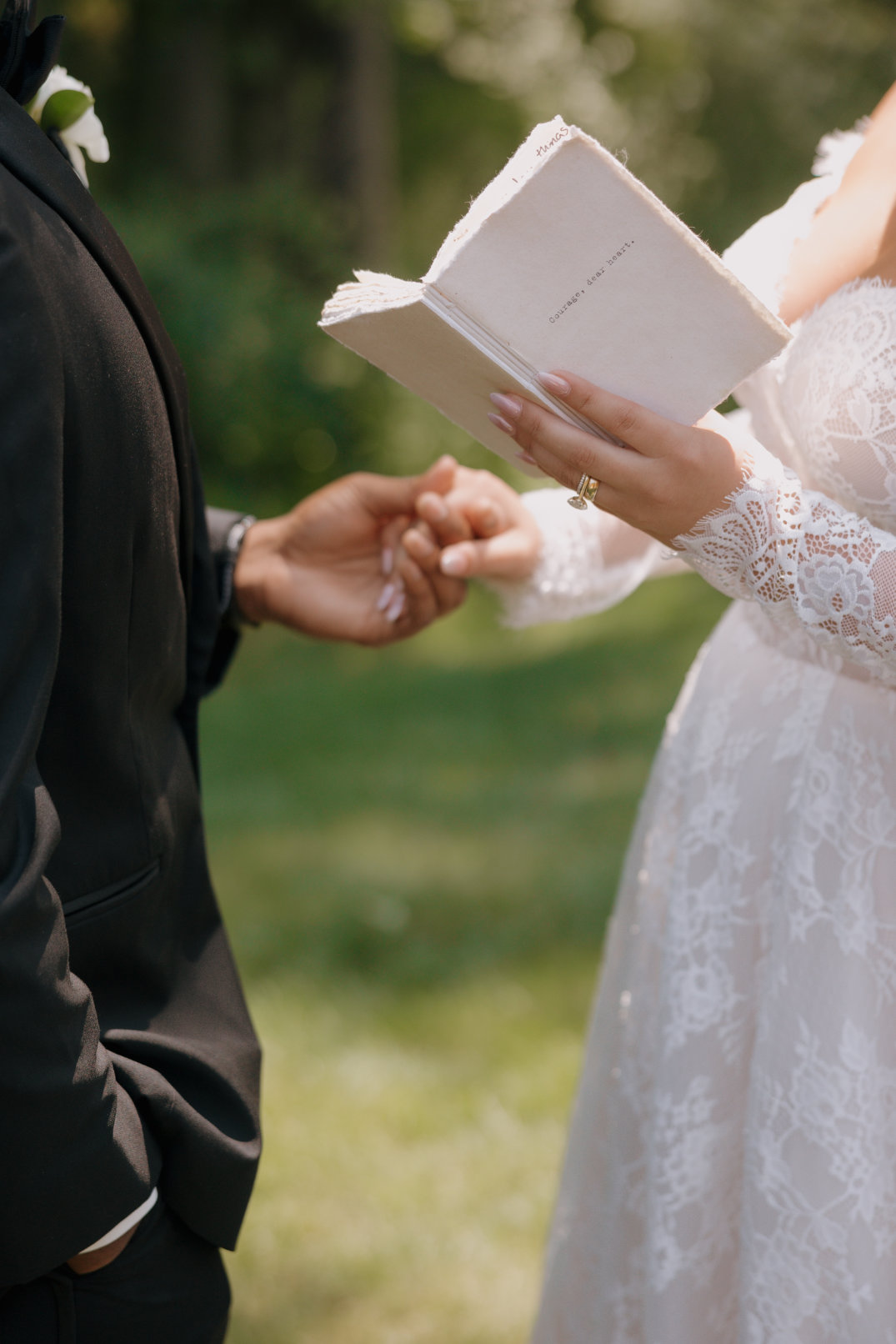 Close-up of hands exchanging rings during the ceremony at The Estate at New Albany.