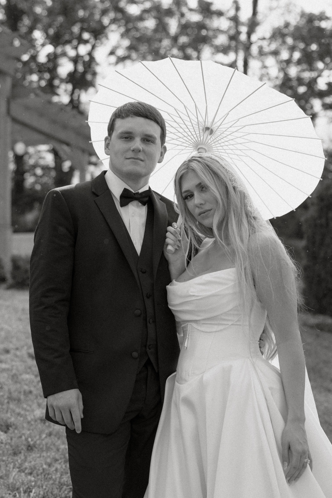 A bride and groom pose together in a romantic black and white photo taken at their Hocking Hills wedding.