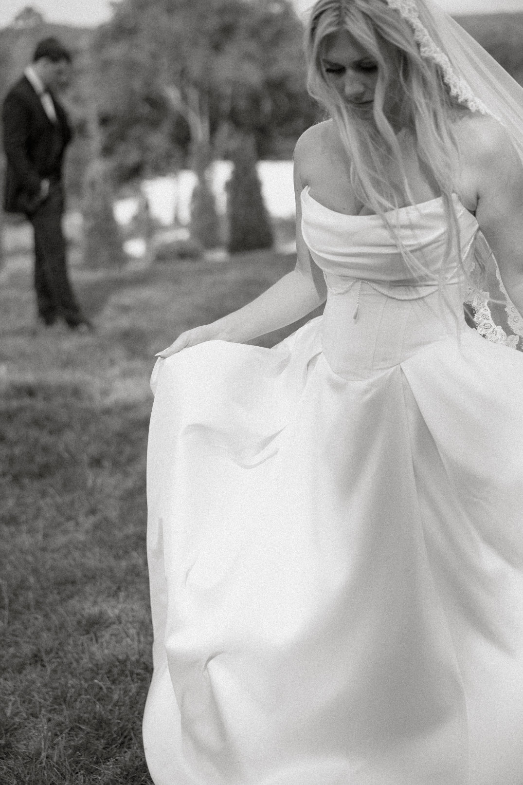 Black and white film detail photo of the bride’s wedding dress fabric and movement at The Seventy Five Venue in Hocking Hills, Ohio, by Chloe Elizabeth Photography.