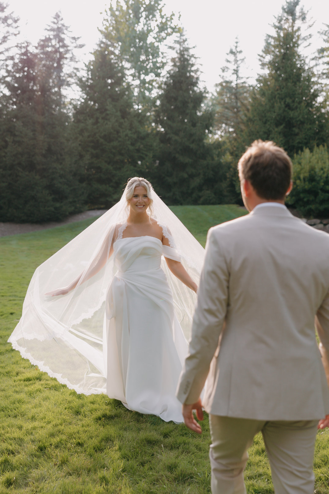 Ohio Bride walking up to her groom for the first time during their wedding day, smiling and showing off her dress.