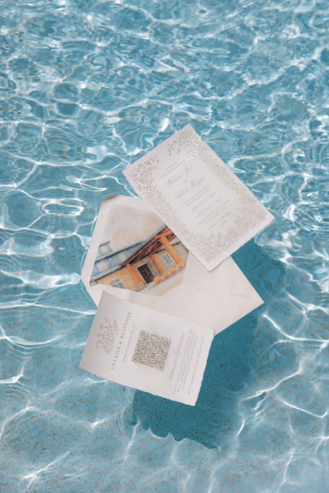 Flat lay of stationery floating in a pool, styled as a quiet pre-wedding detail moment.