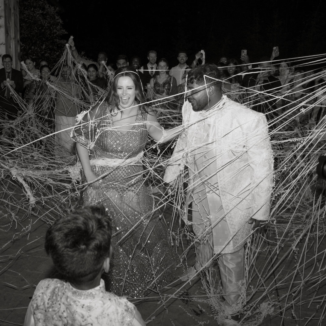 Black and white nighttime portrait of the couple walking together outdoors, captured by film photographer Ohio.
