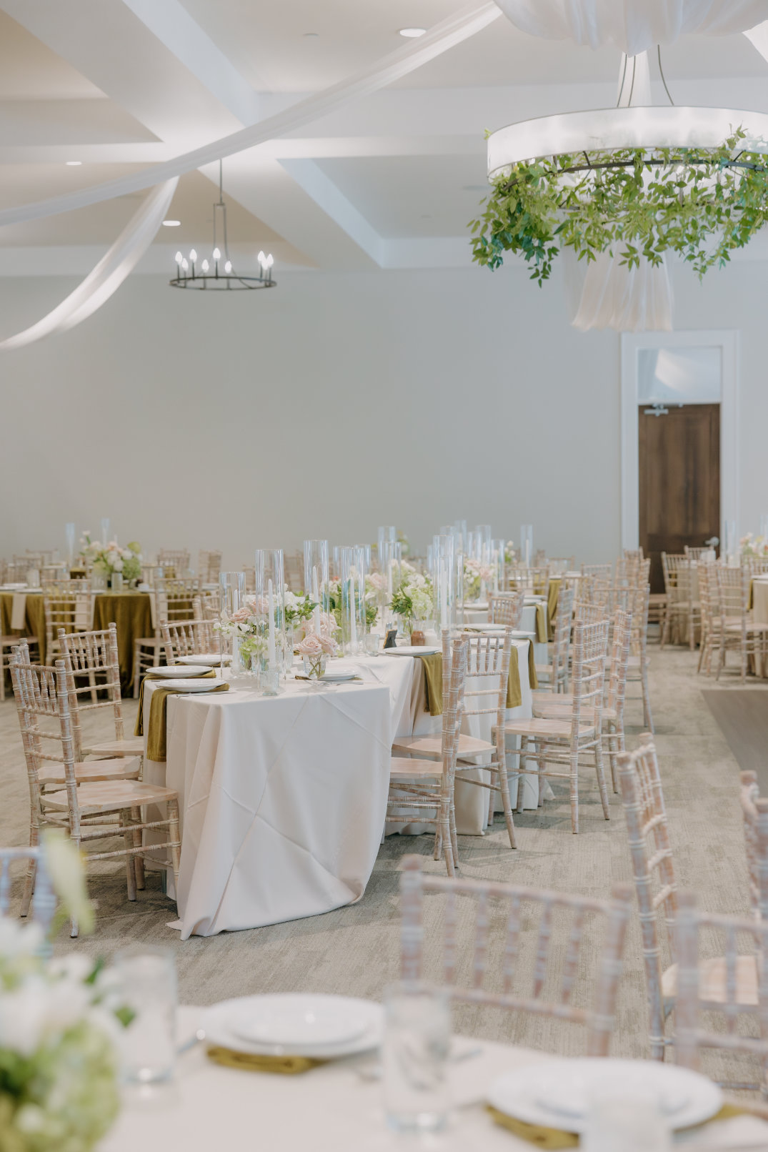 Reception space styled with round tables, linens, and floral centerpieces at The Estate at New Albany